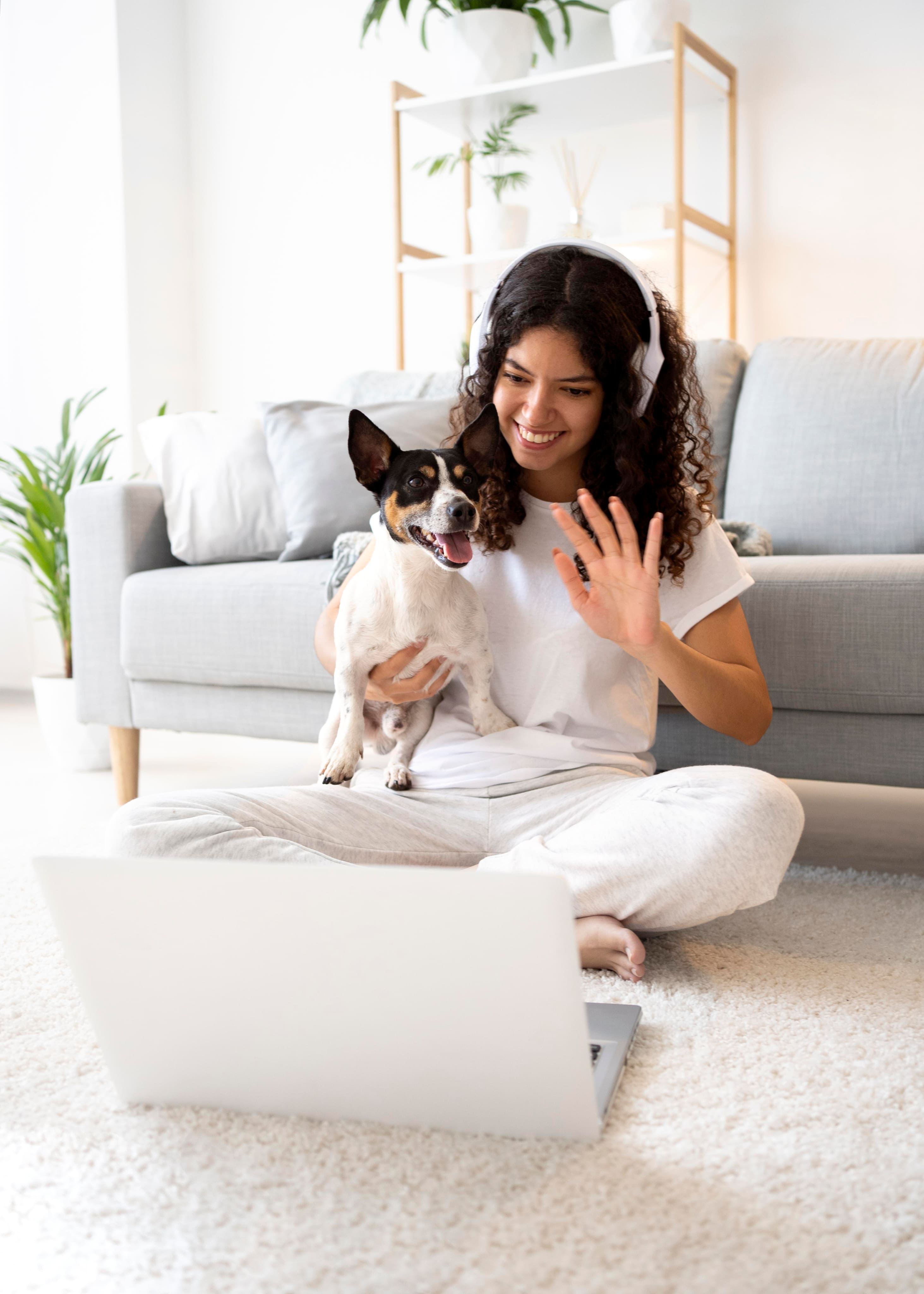 image of a woman wearing headphones and interacting with her dog
